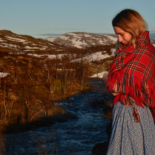 Woman in the mountains wearing a sami scarf